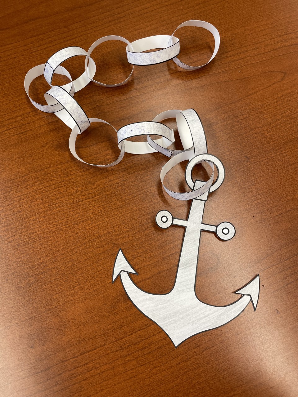 photo of a light gray paper anchor with a paper chain