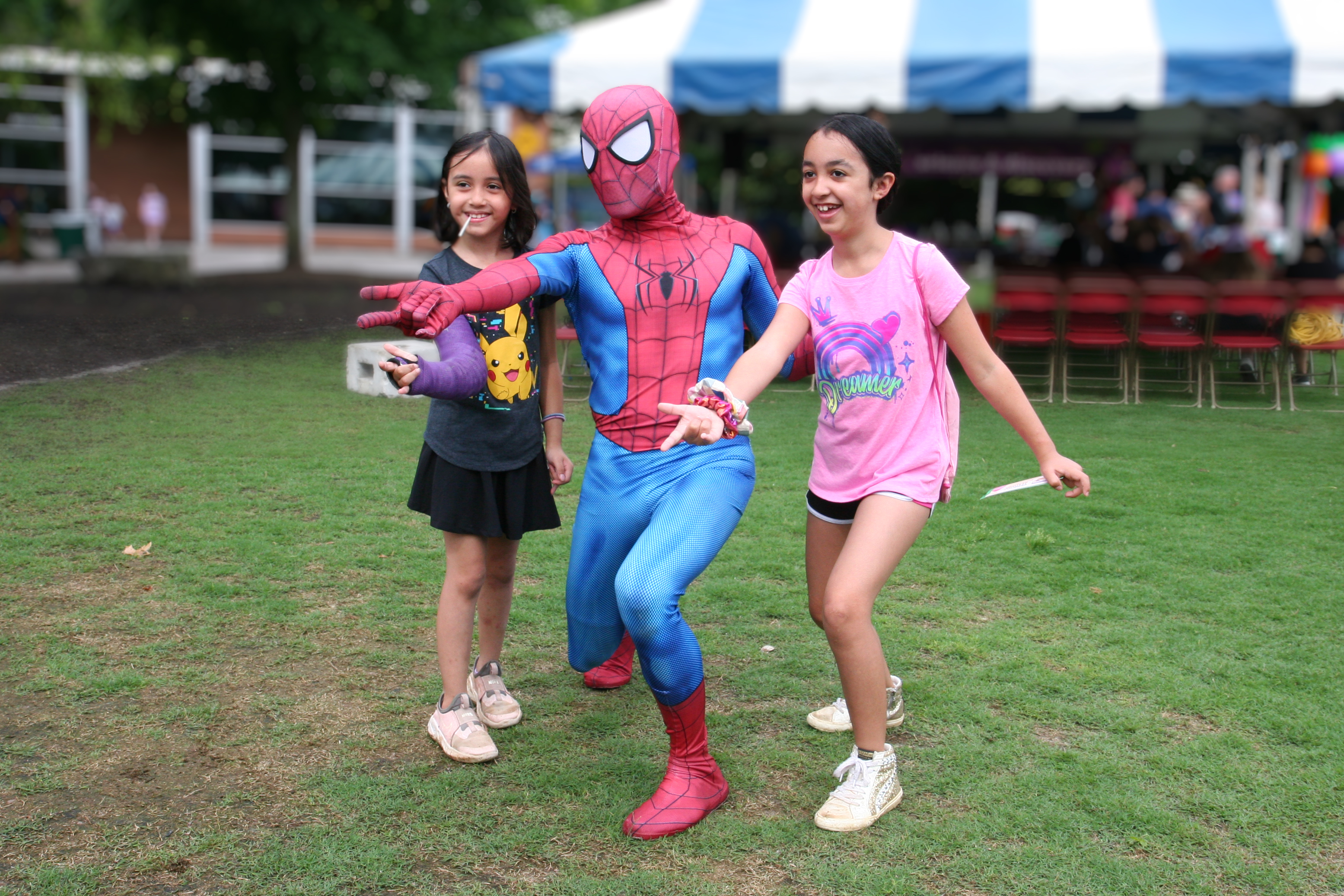 spiderman character "shoots a web" with two kids