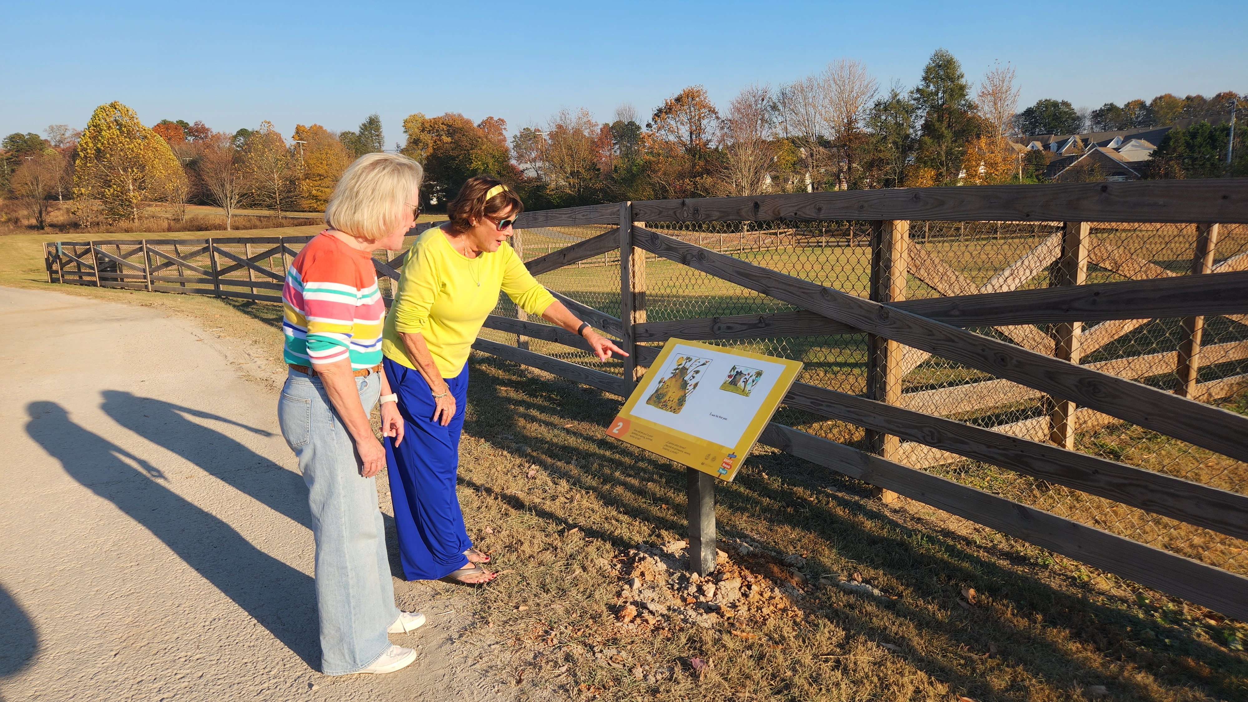 two women read a story trail panel