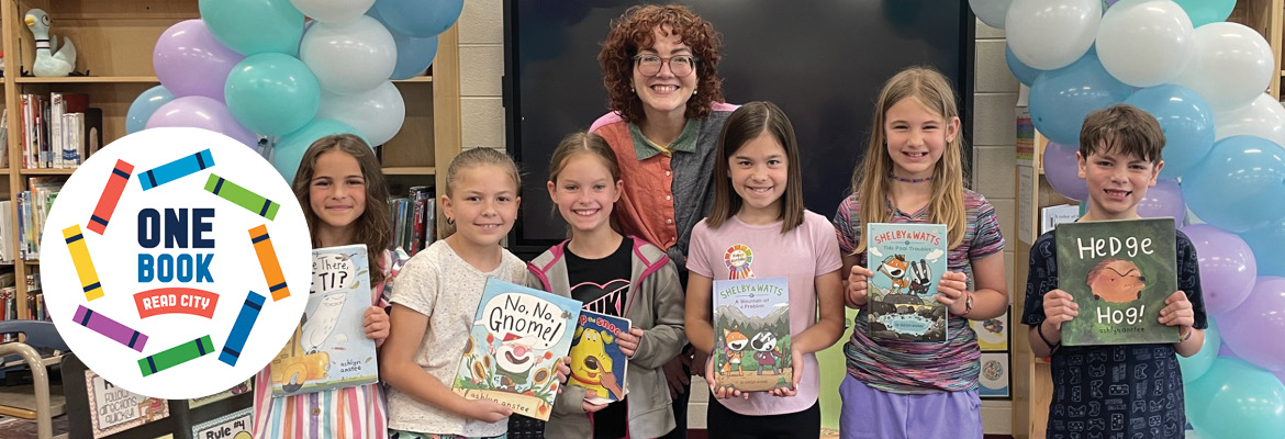 photo of author Ashlyn Anstee and children holding books by her