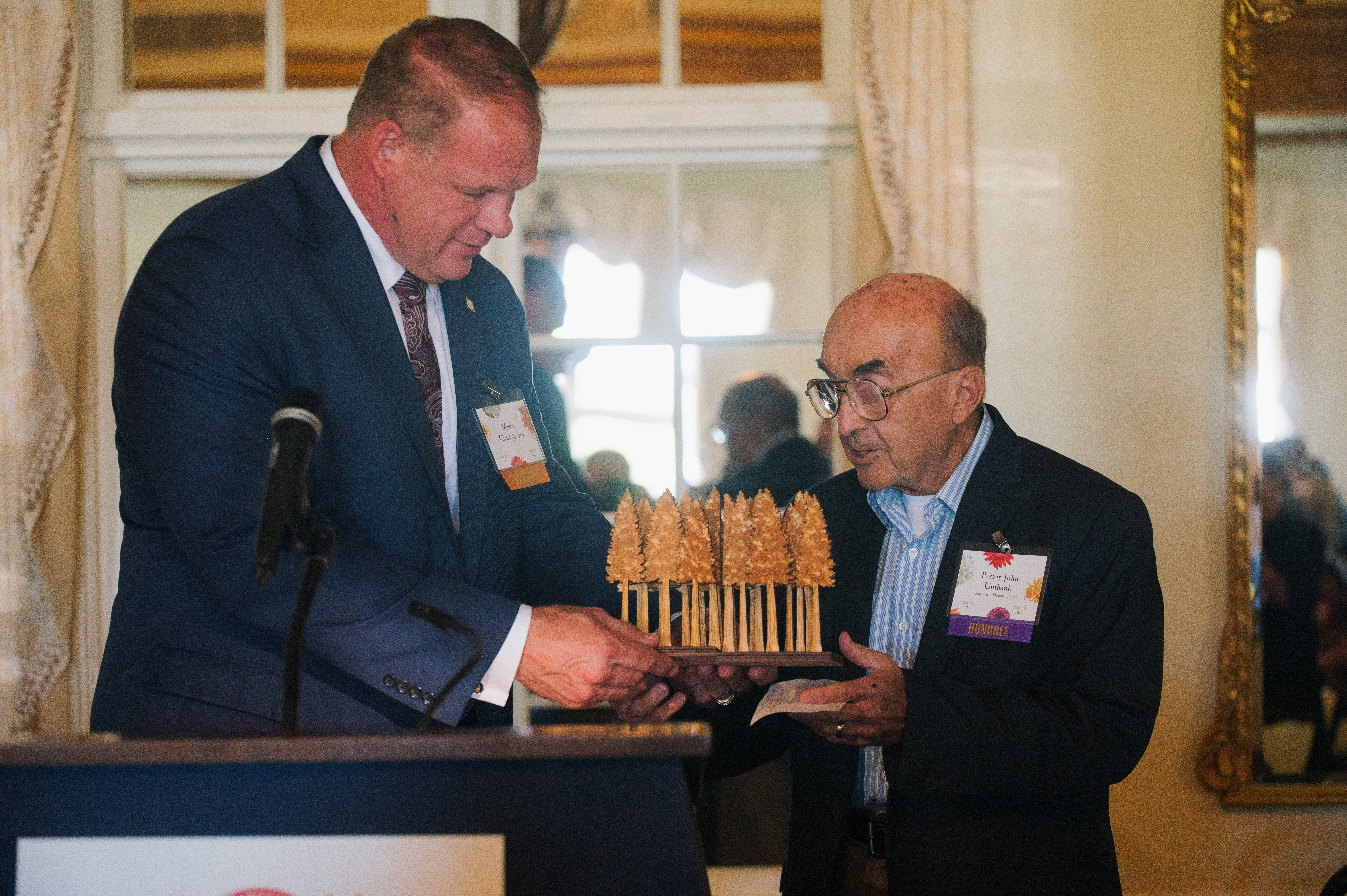 Mayor Glenn Jacobs (left) hands the Seeds of Literacy award to Pastor John Unthank (right), recipient