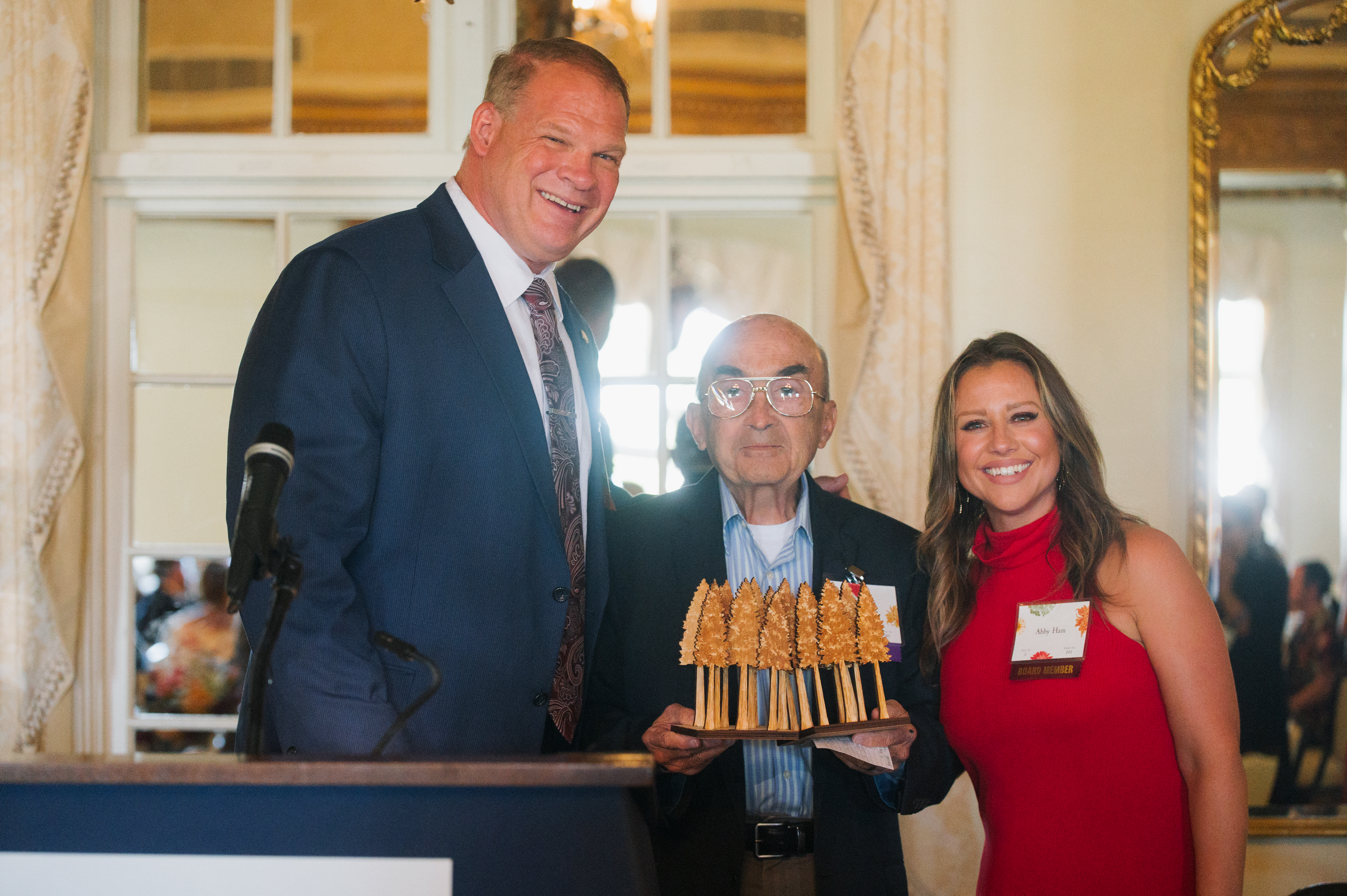 Mayor Glenn Jacobs (left), Pastor John Unthank (center), and emcee Abby Ham (right) pose with the 2022 Seeds of Literacy award