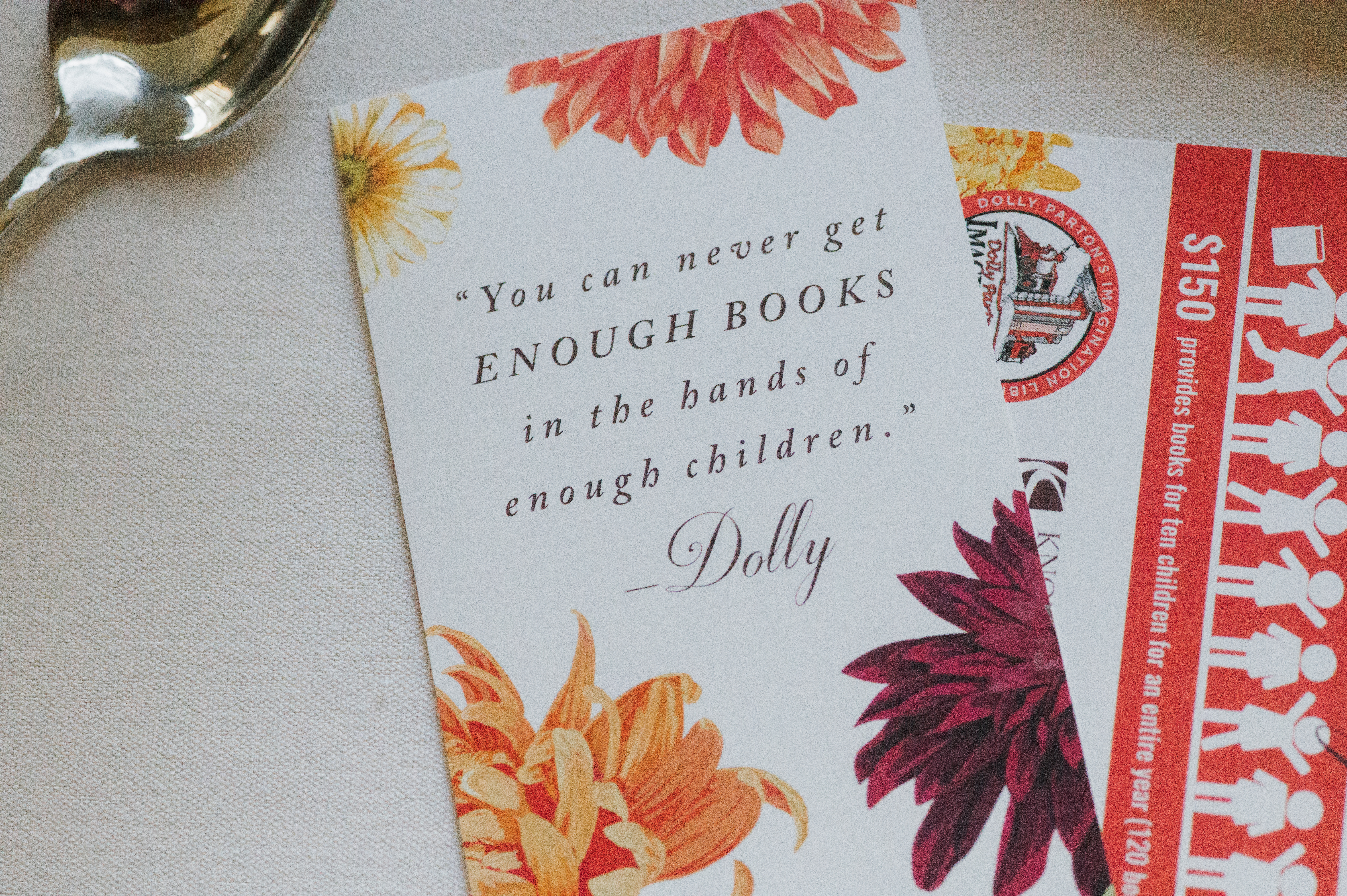 A Seeds of Imagination bookmark bearing decorative flowers and the Dolly Parton quote, "You can never get enough books into the hands of enough children."