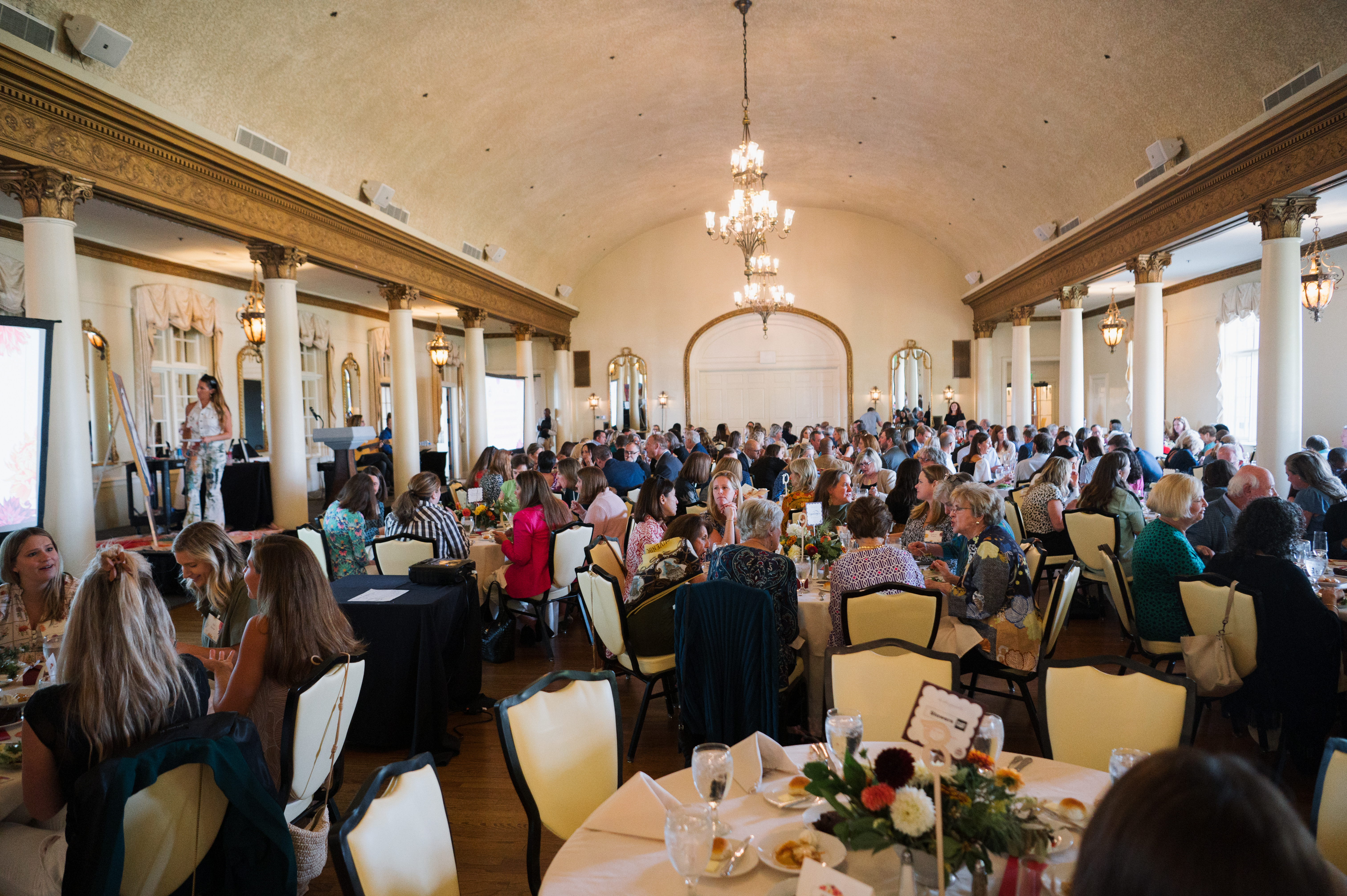 The ballroom of Cherokee Country Club filled with people eating