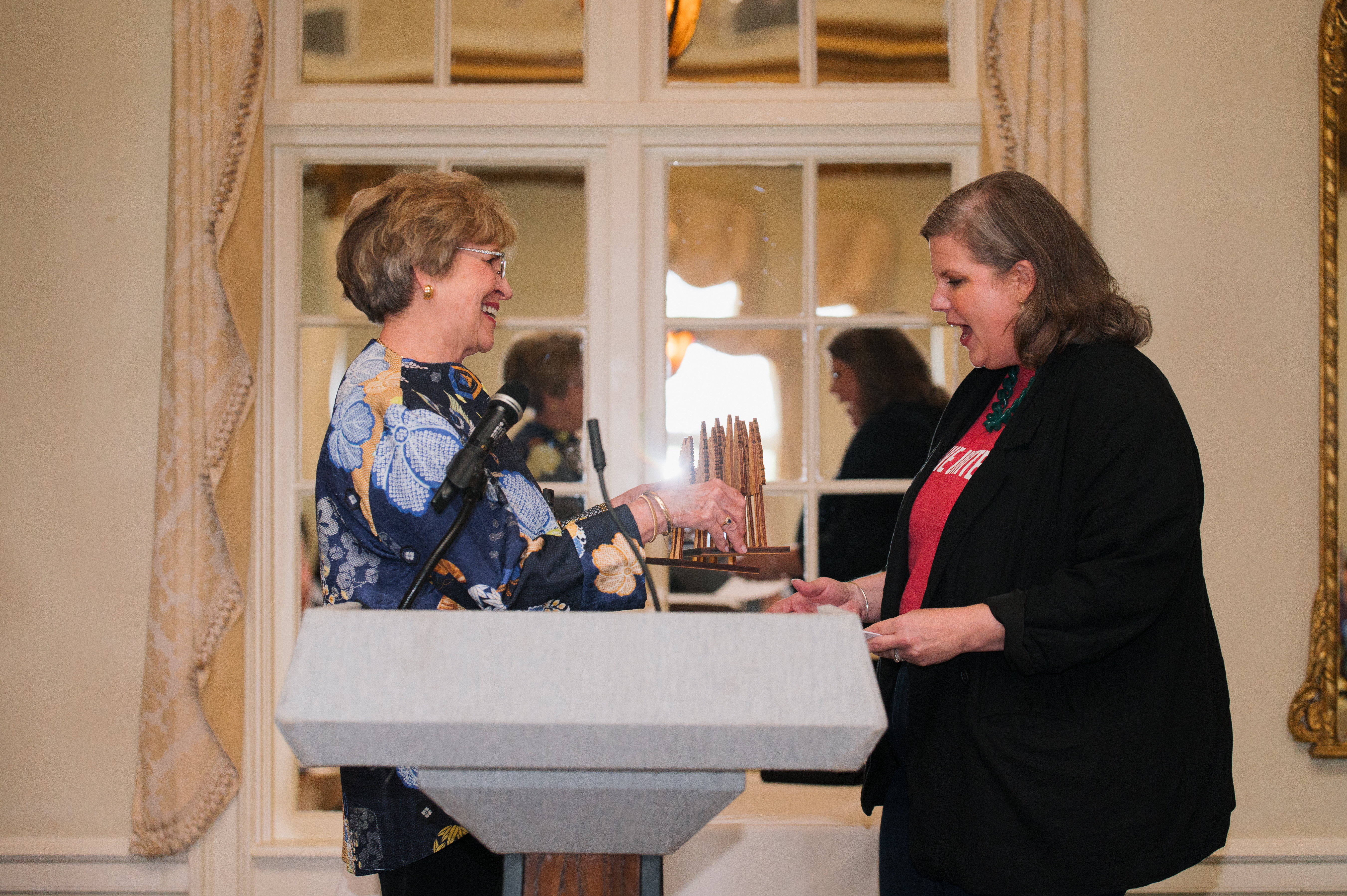 Bonny Naugher, left, presents Ellie Kittrell, right wearing a blazer and a Live United tee shirt, with the Seeds of Literacy award