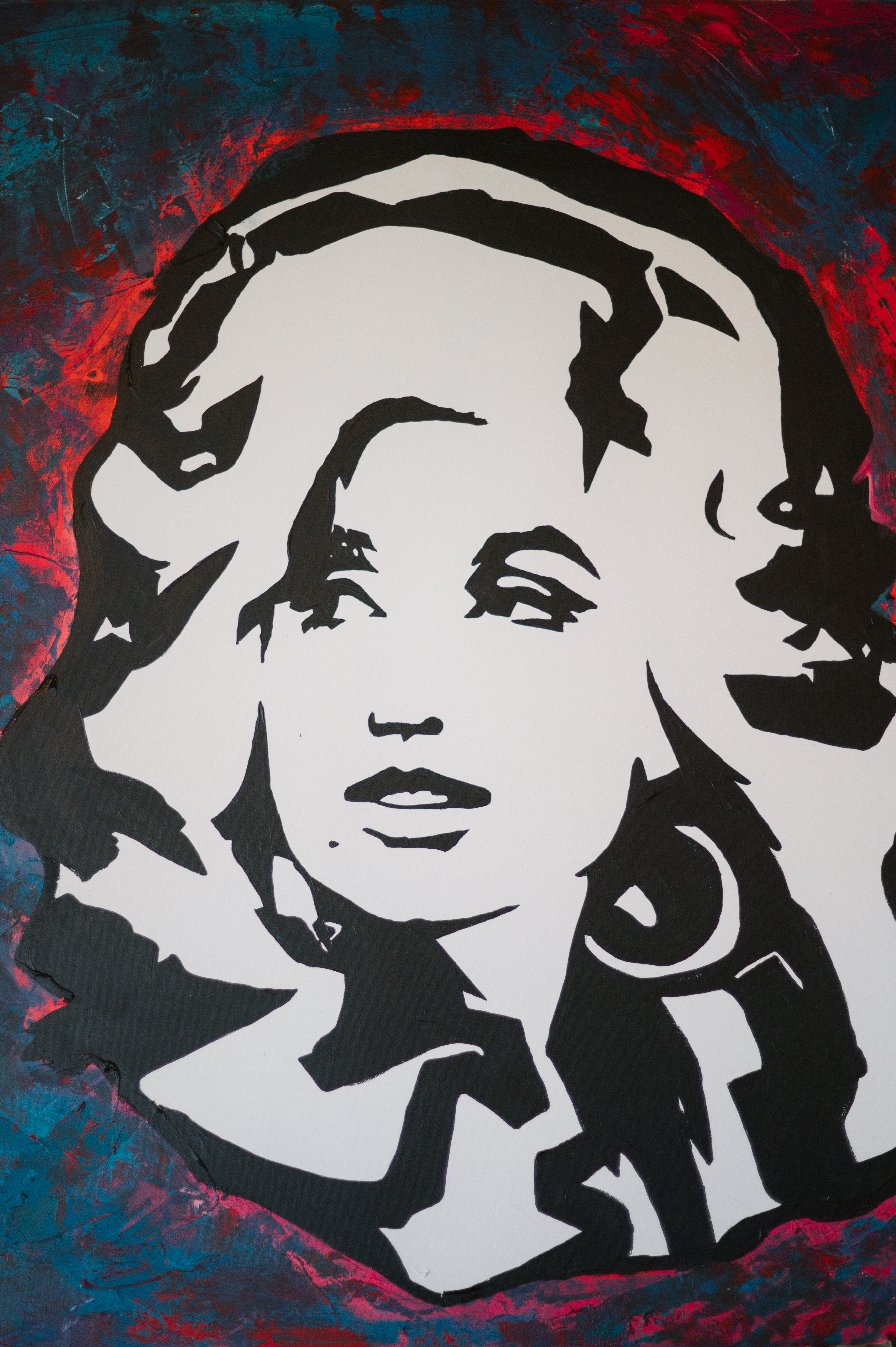 A large acrylic black-and-white painting of Dolly Parton with a red and blue background