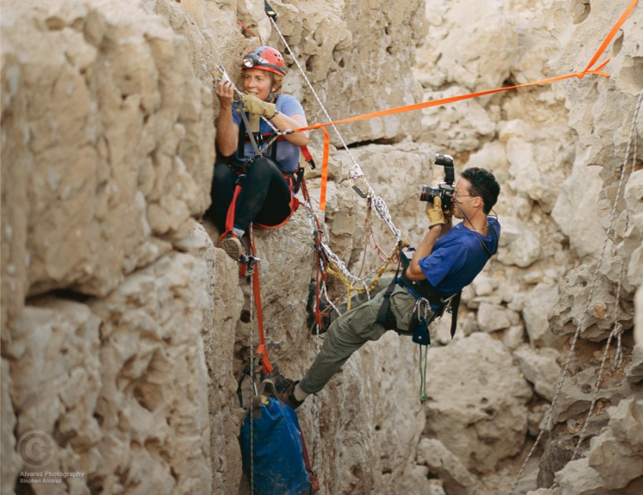 National Geographic photographer Stephen Alvarez on the side of a cliff shooting photos