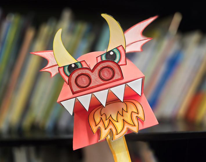 photo of a colorful paper dragon hand puppet